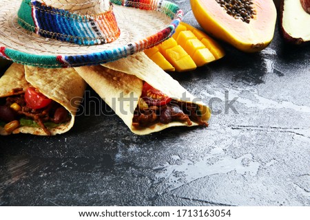 Mexican food mix in colorful colors. sombrero and mexican food with tacos tortillas