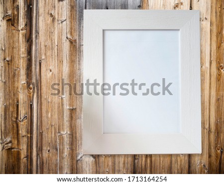 White frame on wooden wall background, mockup