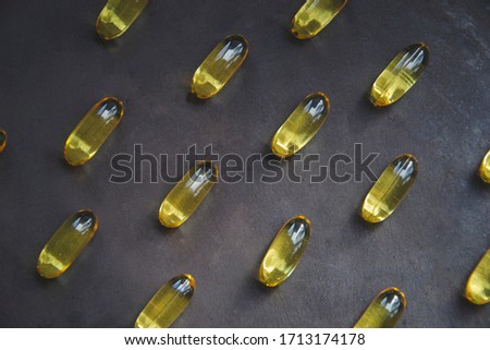 Close up picture of flat lay vitamins. Pills of omega for people. Dark background with medical care for people. Pharmacy flat lay wallpaper. Copy space of medicament care. Covid-19, quarantine.