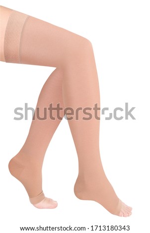 Beige open toe stockings. Compression Hosiery. Medical stockings, tights, socks, calves and sleeves for varicose veins and venouse therapy. Clinical knits isolated on white background
