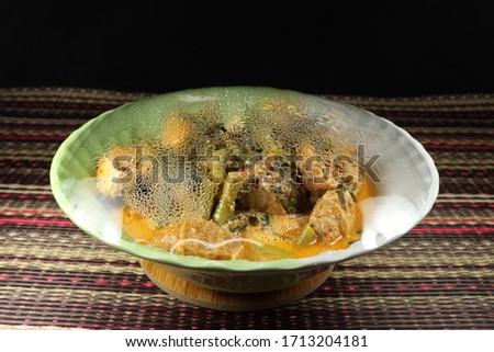 Plastic wrap over the food after reheated in microwave. Clear Plastic shrink is the necessary kitchenware for keeping food clean and warm. Steamed water inside the plastic wrap.  Royalty-Free Stock Photo #1713204181