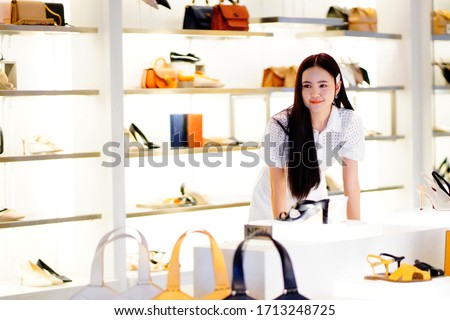 Asian women, Shopaholic Women, carry shopping bags, money, credit cards at a department store. Fashionable Woman likes online sites with black Friday sales signs, lifestyle, digital marketing, fashion