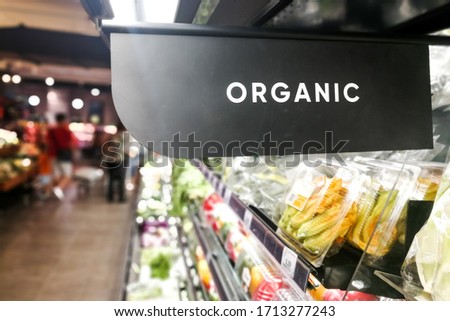 Closeup of organic produce vegetable fruits aisle with signage word in supermarket