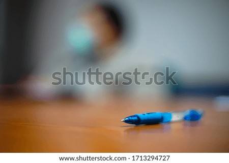 A pen on the table in the meeting room.