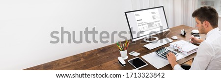Invoice Calculator And Accounting Software On Computer Royalty-Free Stock Photo #1713323842