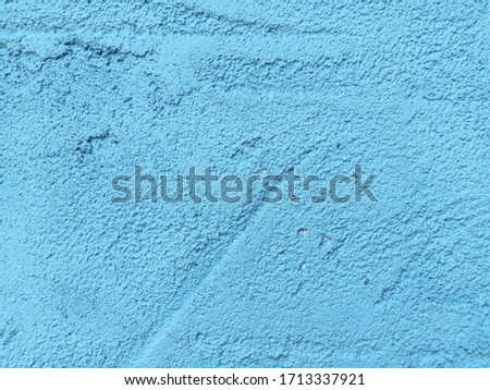 The background is made of blue colored concrete.