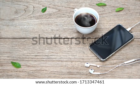 coffee and smartphone on wood table