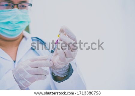 Doctor with syringe ready for injection of vaccine to patient. Vaccination concept.