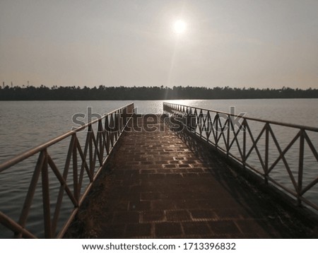 a bridge ending into the lake