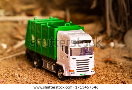 Green Plastic Toy Garbage Truck on Ground. Kids favorite toys 