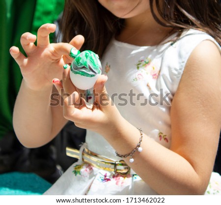 little girl doing egg painting activity