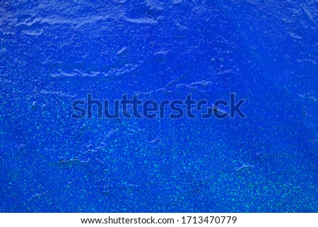 Blue old painted wall with broken plaster. Rough background imitating sea water, underwater world. Copy space