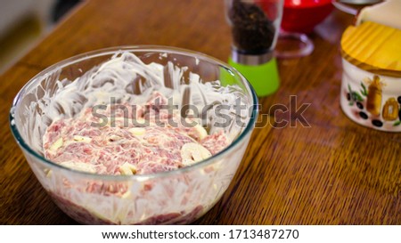 Cooking Meat. Onions And Tomatoes Dance Around The Frying Pan, Then A Plate Of Sliced Meat Appears In The Picture. The Meat, Onion And Tomatoes Stretched Over A Wooden Skewer Are Ready To Roast.