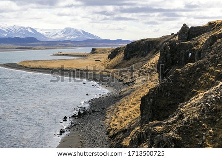 A beautiful calm lake and the volcanic soil in Iceland.