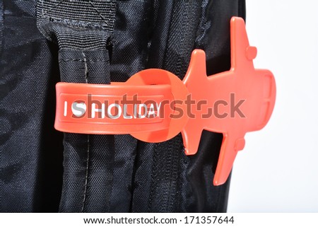 I LOVE HOLIDAY name tag on black luggage