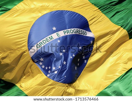 Flag of Brazil moved by the wind in the sky Royalty-Free Stock Photo #1713576466