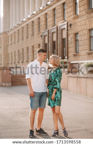 
Young couple in love is hugging. In the city, a summer love story. Full height photo