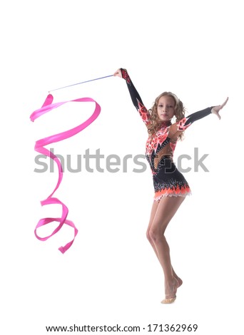 Graceful little gymnast dancing with ribbon