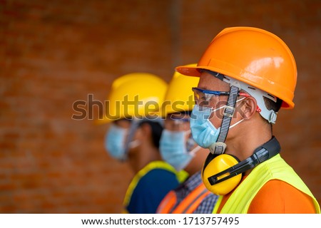 Technician wear protective face masks safety for Coronavirus Disease 2019 (COVID-19) in machine industrial factory,Coronavirus has turned into a global emergency. Royalty-Free Stock Photo #1713757495