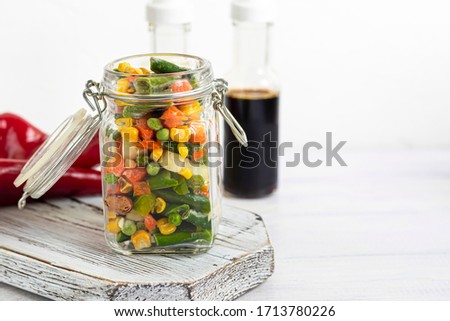 Frozen vegetables. Frozen vegetable mixture of carrots, corn and peas, celery and corn. Mexican mix. On white background.