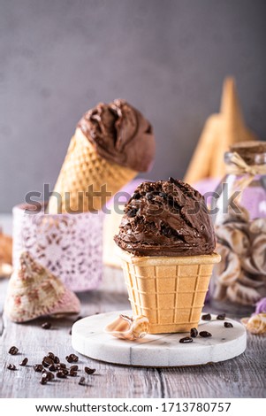 Delicious summer dessert chocolate ice cream in waffle cone. Summer healthy food concept, lactose free. Copy space.