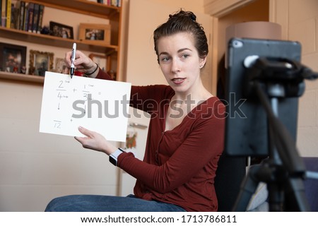 School teachers are forced to teach their lessons from home using their phones to video themselves Royalty-Free Stock Photo #1713786811