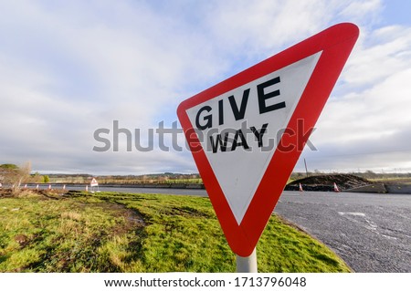 Give Way road sign at a road junction in the United Kingdom