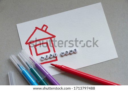 Drawing house with words Stay Home from letters and multi-colored markers. Stay at Home picture. Coronavirus concept.