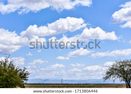 Cloudy sky with green landscape