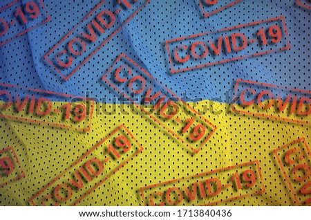 Ukraine flag and many red Covid-19 stamps. Coronavirus or 2019-nCov virus concept