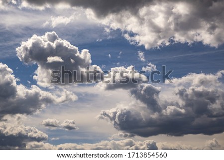 Blue sky background with tiny stratus cirrus striped clouds before storm. 