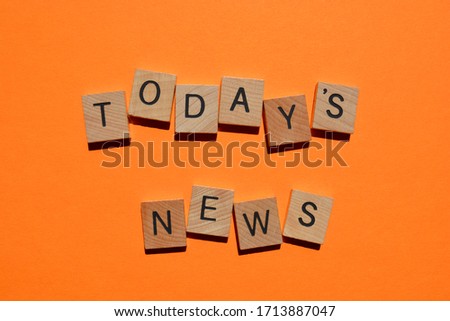 Today's News, in 3d wooden alphabet letters isolated on bright orange background