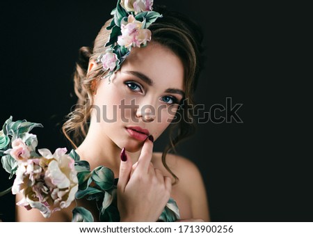 Beautiful woman with handmade flowers made of genuine leather and silk. High resolution photos. Space for text.