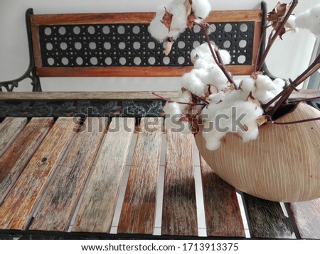 wooden table with vase and bench