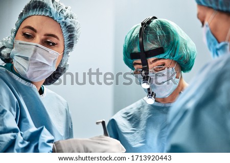 A team of surgeons is fighting for life, for a real operation, for real emotions. The intensive care team is fighting for the life of the patient. Saving life, the struggle for life. Royalty-Free Stock Photo #1713920443
