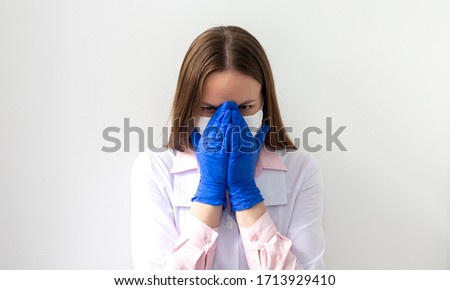 Crying unhappy upset medical nurse / doctor sad and depressed having stress breakdown. Isolated female on white background.