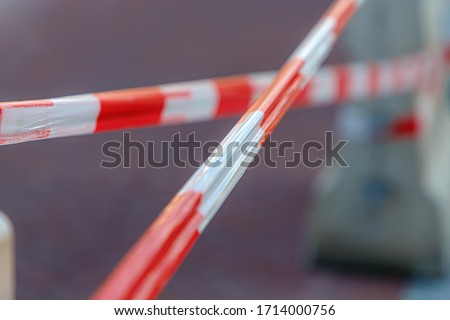 Soft selective focus barricade tape, Brightly colored tape in white and red, Keep people way from closed area, Outdoor construction, Street renovate.