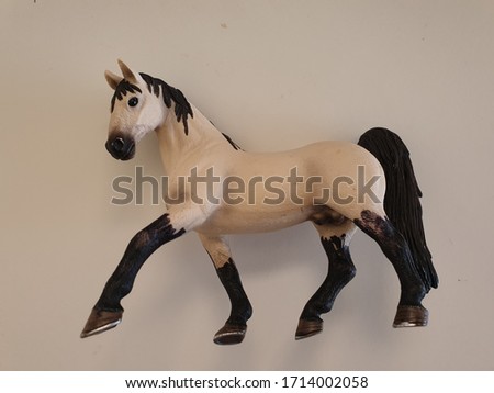 A white stallion horse model and toy for kids to play with