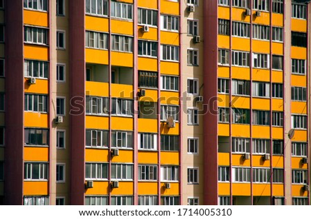 The wall of a residential panel modern house, Windows, balconies, air conditioners on the walls. Royalty-Free Stock Photo #1714005310