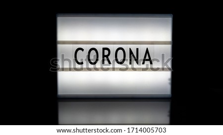 Corona letters on a light box on reflective surface