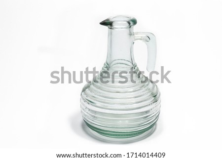 Old glass vinegar bottle on white background