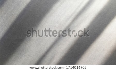 Diagonal shadows on blue dark gray paper. Abstract backgorund. Stock photo.