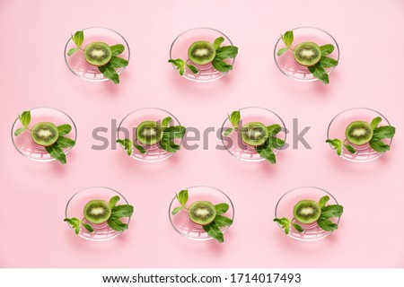 juicy vegetarian fruit pattern of kiwi and mint on a pink background culinary