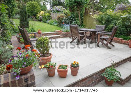 Hard landscaping, new luxury stone patio and garden of an English home, UK Royalty-Free Stock Photo #1714019746