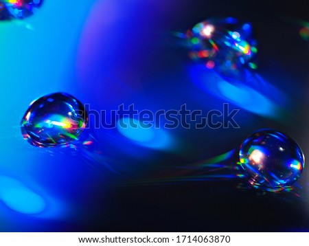 blurred water drops on a CD with rainbow reflecting in the droplets ,blue light and shiny, abstract colorful background, creative wallpaper, sweet color ,copy space ,digital fantasy effect ,macro
 
