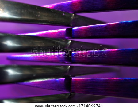 Closeup silverware with colorful light, macro image ,abstract dark blue blurred background 
 