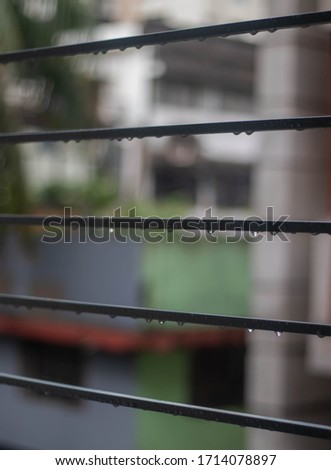 Droplets of water after the on the window grille after rainy season.selective focus