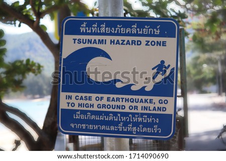 Tsunami hazard zone sign next to the beach.
