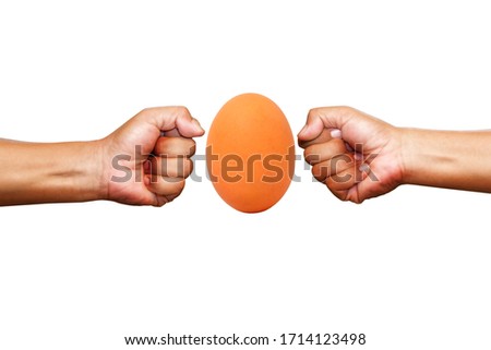 Professional box fight and dieting concept. Hand fist and brown egg isolated on white background.