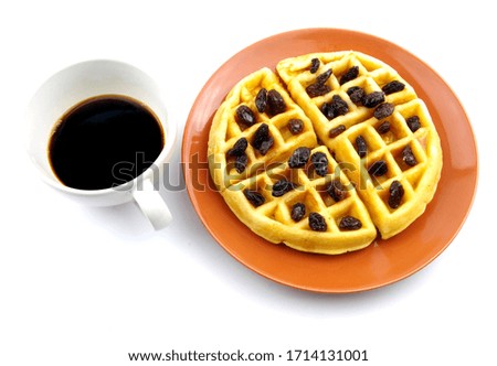 Waffle sweet cake with 
currant on top and black coffee.